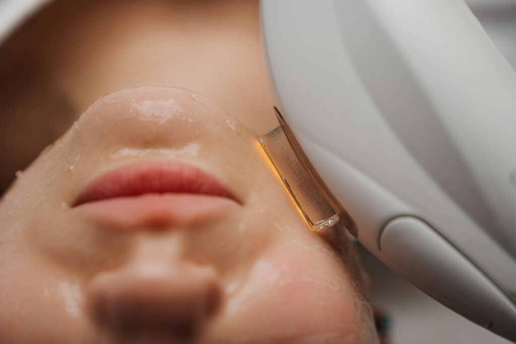 Phototherapy, photorejuvenation, IPL in a beauty salon. Care for a woman's face.